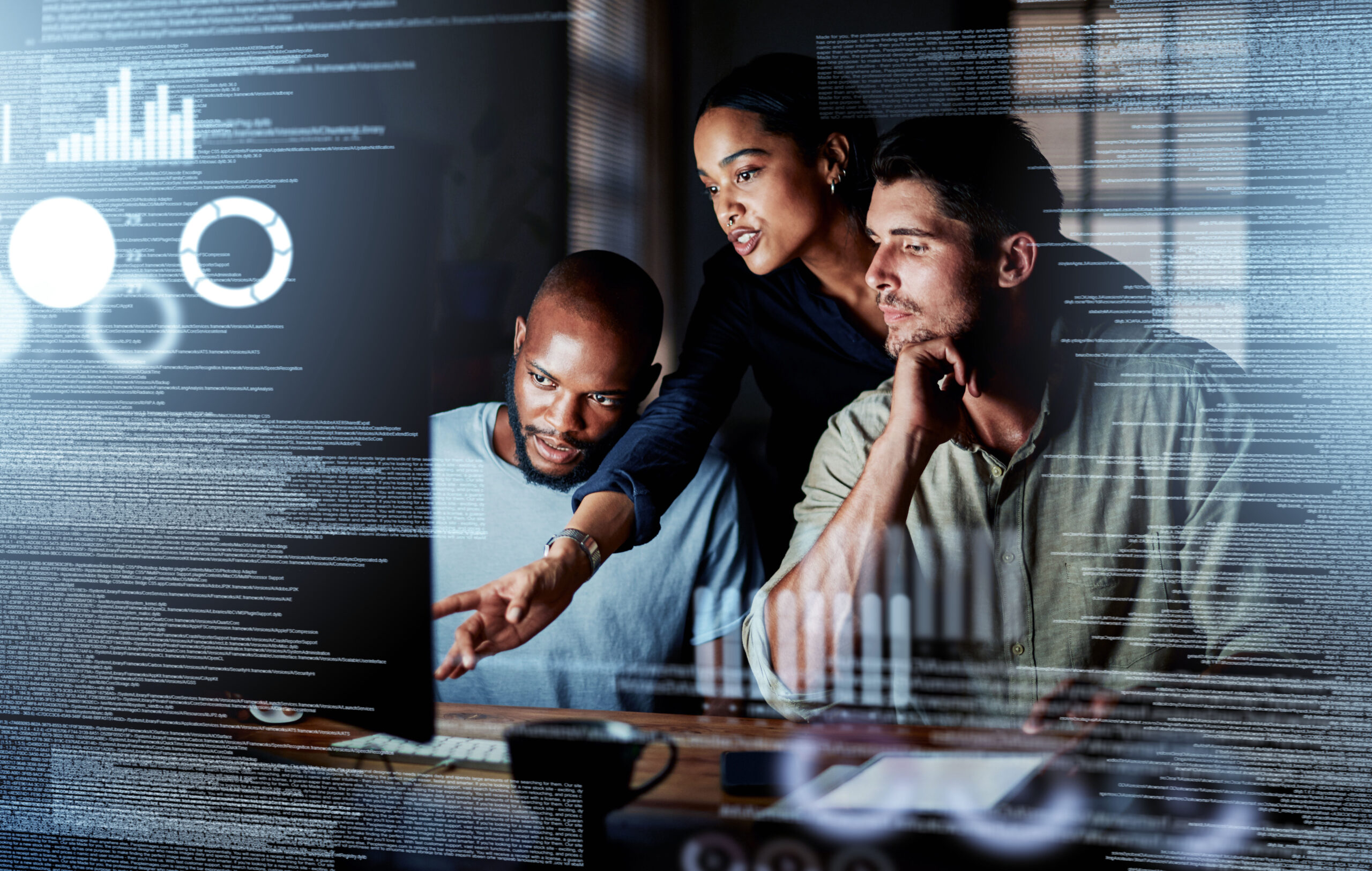 A group of diverse professionals reviewing and discussing data visualizations on a computer screen, illuminated by digital information overlays.